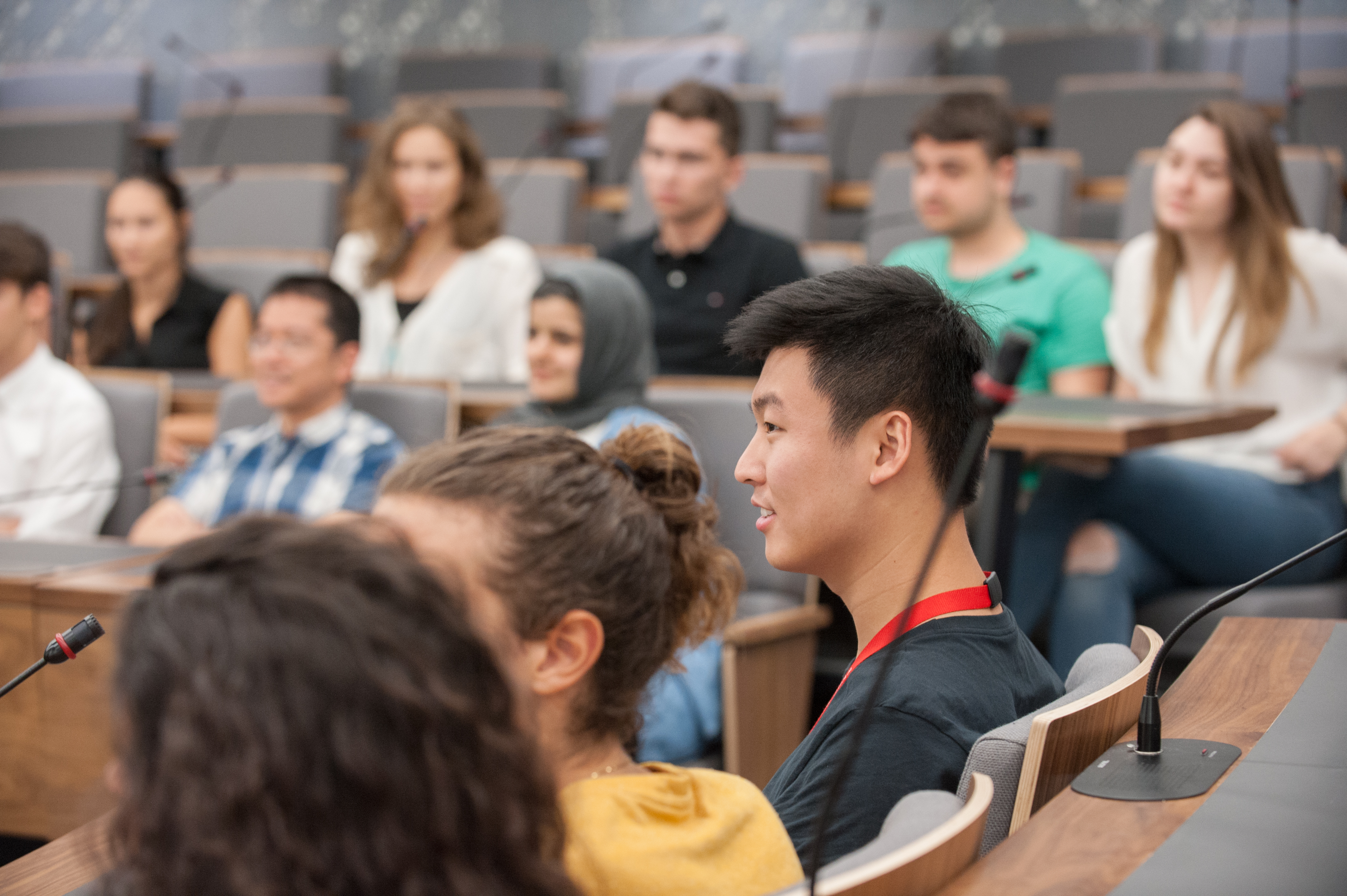 Male and female students taking part in a seminar.