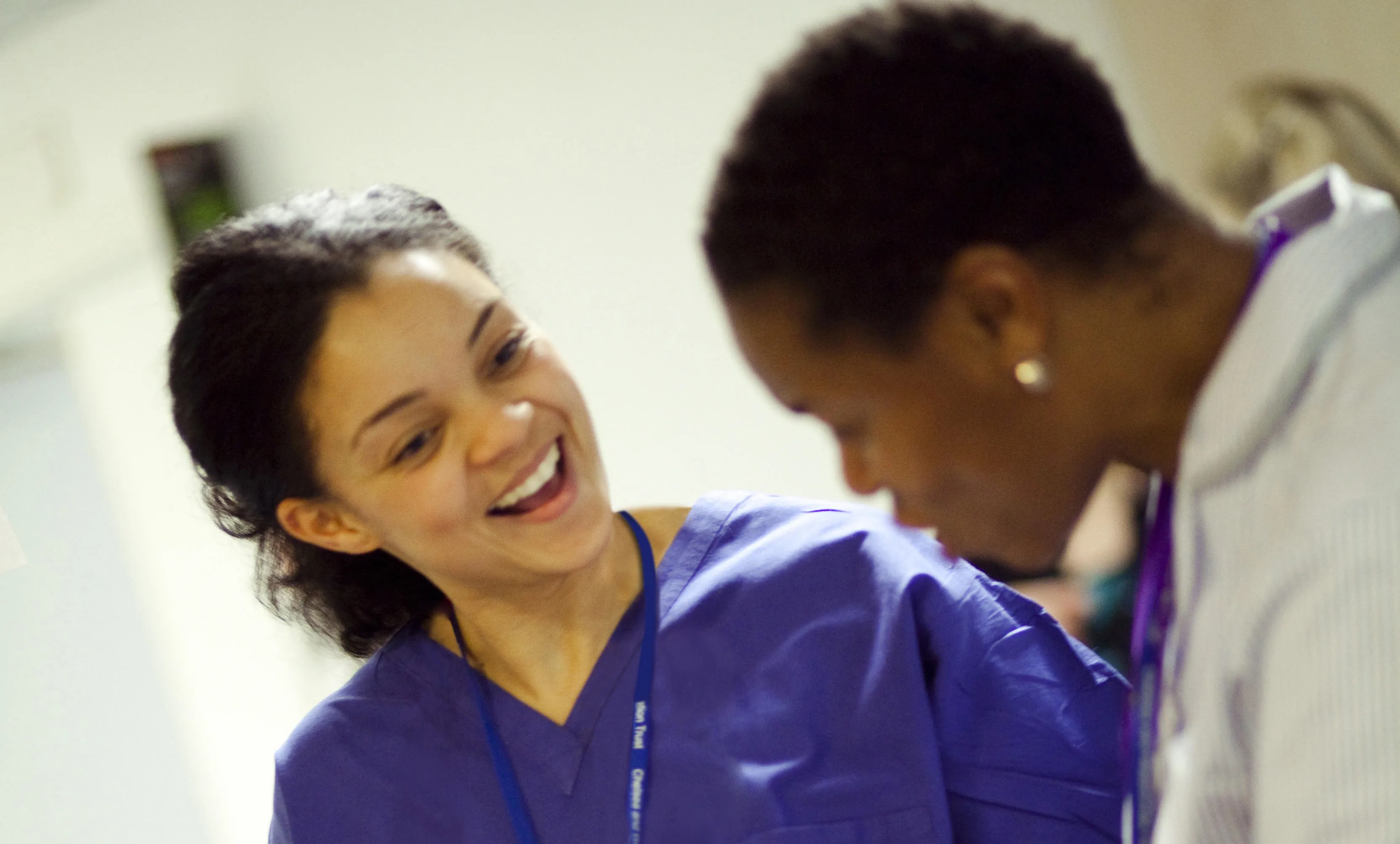 Two uniformed NHS colleagues talking