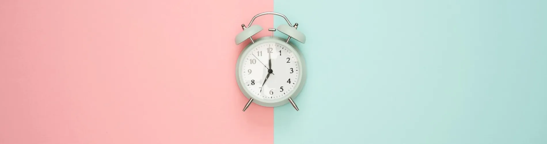 Alarm Clock in a pink and blue half and half background