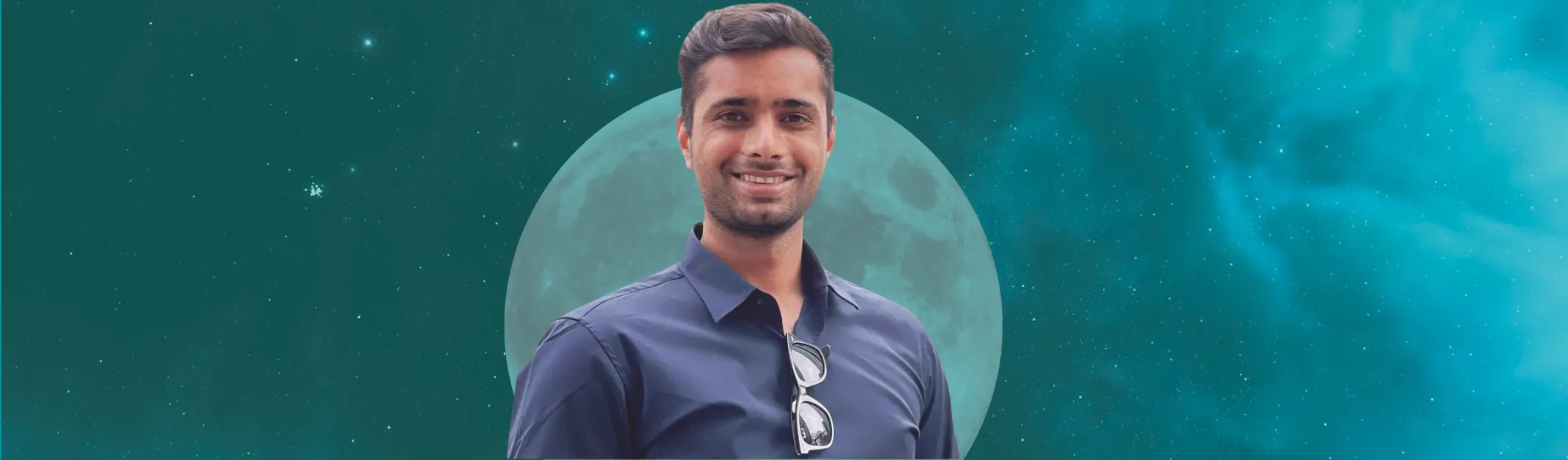 Man smiling in front of blue starry background