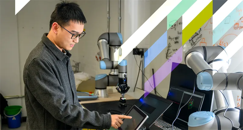 An Engineering student demonstrates robotics with his laptop