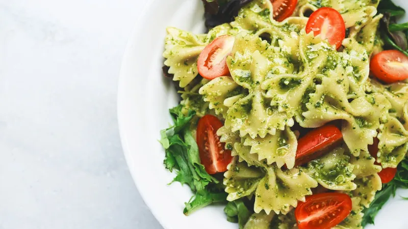 Pesto Pasta topped with tomato slices