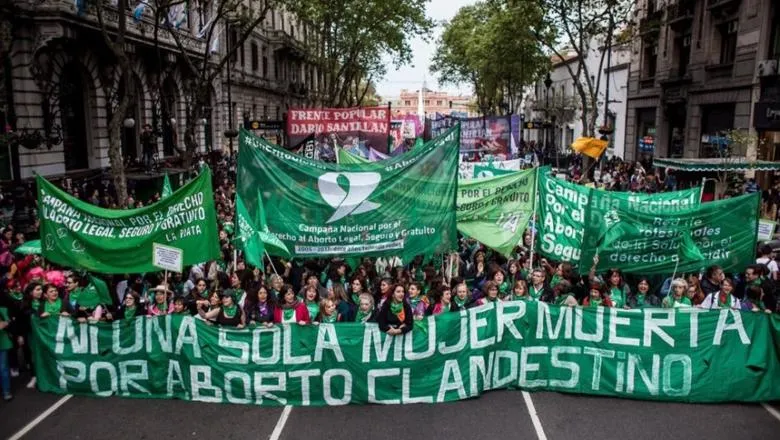Protesters holding a sign stating Not a single woman dead as a result of clandestine abortion’