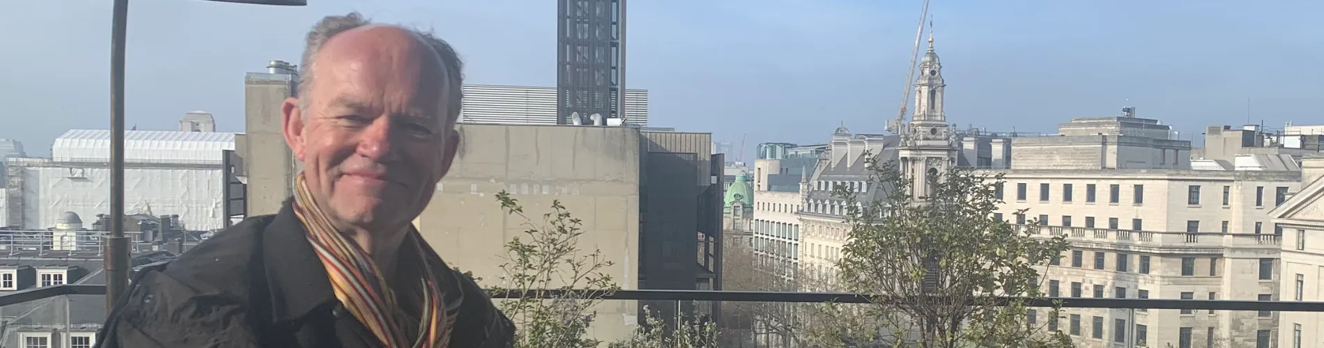 Professor Alan Read standing in front of a rooftop view